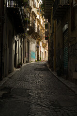 Fototapeta premium Cobblestone Street Under Glowing Lights