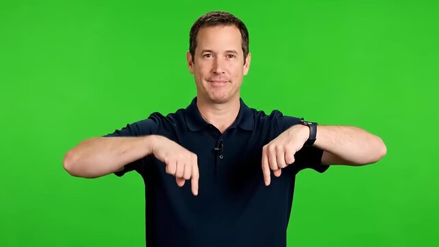 Man pointing down in front of green screen, inviting engagement with content below