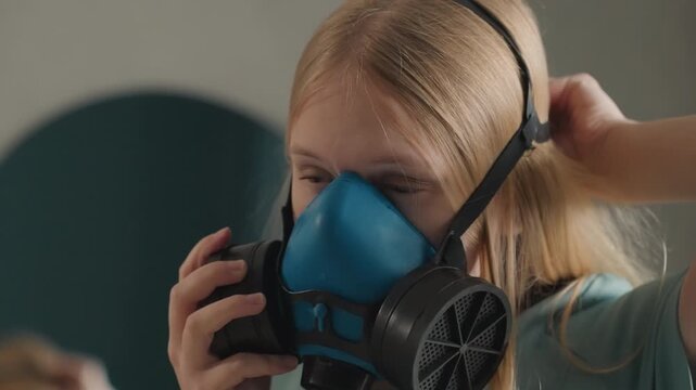 Female prepares for intense cleaning session carefully. Woman equips herself with safety gear before cleaning activities. Diligent woman secures mask before undertaking thorough cleaning in cozy room