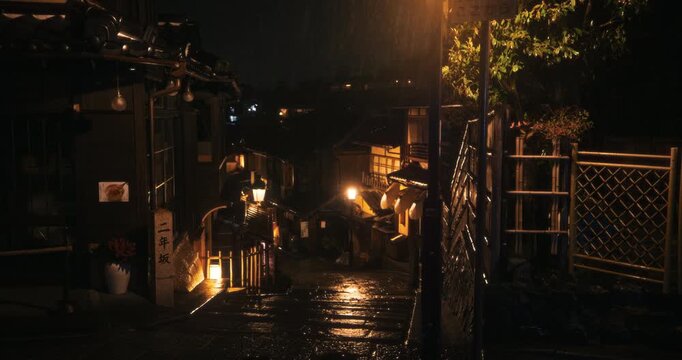 Cinematic tracking shot of beautiful, old Japanese village at night while it rains