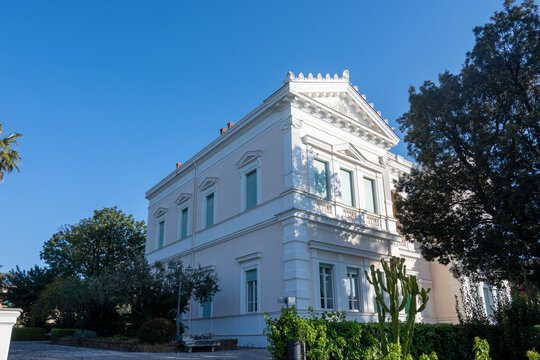 View on classical, elegant historic Italian villa nestles in lush Mediterranean gardens near the sea, romantic holidays, wedding place