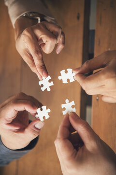 Vertical Stakeholders business trust teams hands holding jigsaw puzzle synergy. Vertical Horizon Implement puzzle improve solve synergy organize team building connection plan trust service strategy