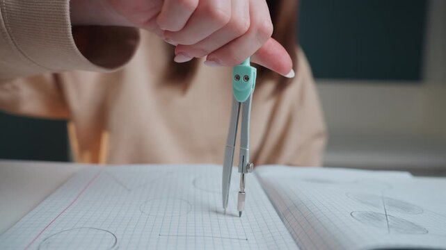 Student practicing geometry with compass. Focused student illustrating precise angles and shapes quietly. Calm student concentrating on detailed compass work with ruler and notebook at home