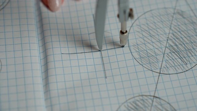 Closeup compass drawing precise circle arc on grid paper, technical drafting scene with steady hand and metal instrument, intersecting shaded circles and careful measurement, focused math