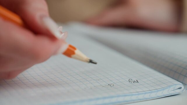 Closeup hand writing grammar exercises, grid notebook, careful pencil strokes, faint eraser residue, focused study mood, tutor guidance implied, quiet indoor evening light, neat fingernails visible,