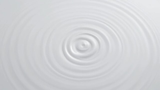 White Liquid Surface with Concentric Ripples Expanding Gently and Smoothly.