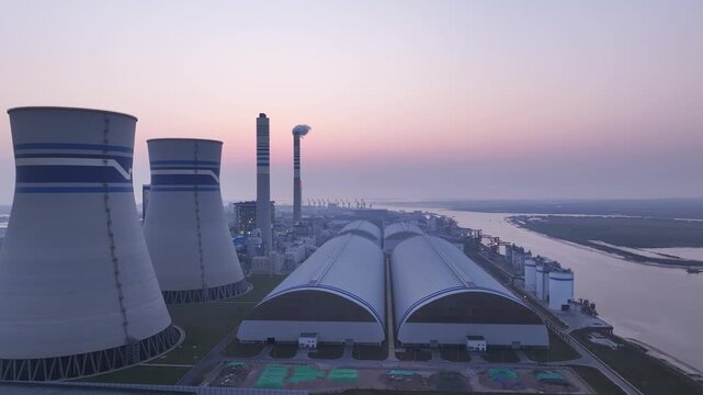 Coal fired power plant by river at dawn