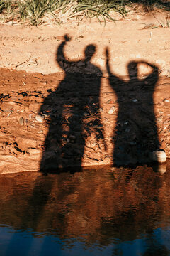 A couple of people shadows waving.