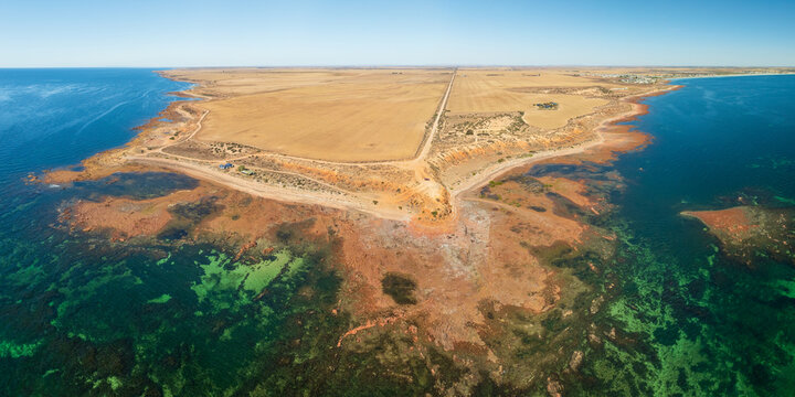 Aerial panorama view of a remote arid headland above a rocky coastline