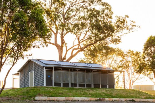 Gum trees around toilet block building with solar panels on roof