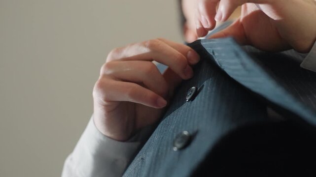 Lowangle caucasian executive fastening jacket buttons, poised in boardroom lighting, crisp white shirt and pinstripe waistcoat, decisive movements and professional focus, corporate morning ritual,