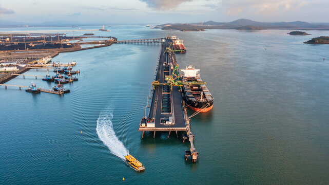 RG Tanna coal ship and wharf with coal piles in the background