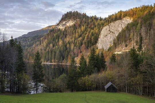 The Schwarzensee and surrounding mountains in autumn. Trees in autumn leaves. Sun and clouds. St. Wolfgang, Salzkammergut, Upper Austria, Austria