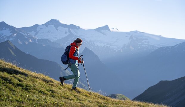 Hiker enjoying the mountain panorama in the morning, Venediger group, behind Dreiherrenkopf, Simonysitze and Gro&szlig;er Geiger, Hohen Tauern, Austria