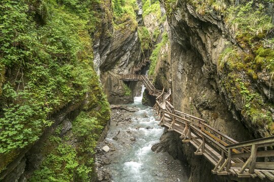 Wooden footbridge on a rock face at the mountain river Kapruner Ache in gorge, Sigmund-Thun-Klamm, Kaprun, Salzburg, Austria