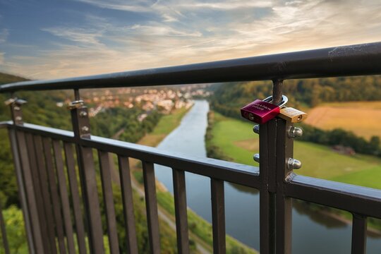 Two love locks on the railing, view from the skywalk onto the Weser towards Bad Karlshafen in the evening, Beverungen, H&ouml;xter, East Westphalia, Weserbergland, North Rhine-Westphalia, Germany