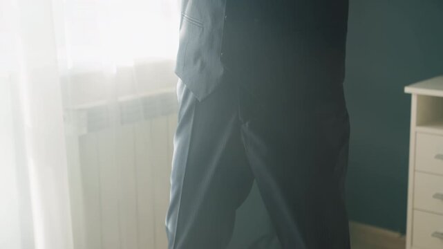 Young man in suit wearing respirator, polished oxfords on wooden floor, sunlit curtains and soft backlight, formal vest and tie, tense cinematic mood, surreal prep and anxiety captured in close detail