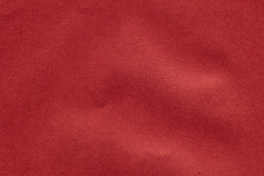 Coral red paper texture with smooth finish and natural tonal variations. Abstract background ideal for graphic design, branding and creative projects.