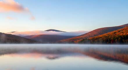 Naklejka premium Serene Sunrise Over Misty Mountain Lake Reflection