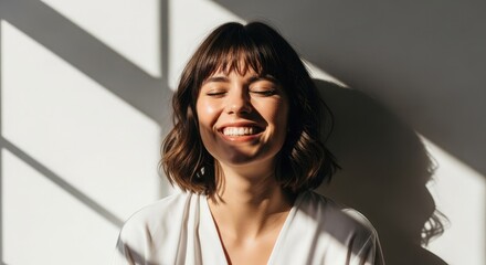 Fototapeta premium Radiant young woman with short hair enjoying sunlight expressing joy and positive emotions natural light portrait