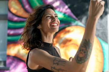 Joyful woman with colorful mural © Rawpixel.com