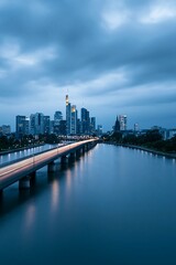 Fototapeta premium Modern City Skyline and Bridge Over Water at Twilight with Light Trails