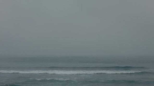 Rough waves crashing onto a sandy beach