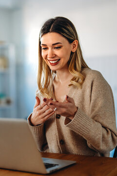 Home office. One smiling woman using laptop. Work, freelance, social media, technology concept.