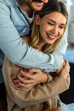 Happy couple smiling and enjoying a loving relationship at home, expressing joy and shared happiness