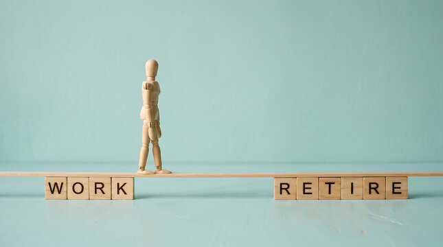 Wooden mannequin walking on a narrow plank between the concepts of work and retirement life goals