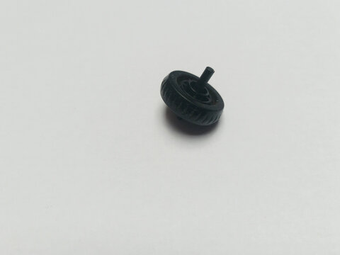 Black plastic mouse scroll wheel macro shot. Universal computer hardware repair component
