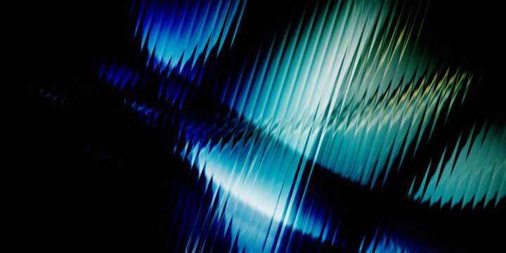 Abstract texture with sharp blue and green light rays cutting through dark space in dynamic motion.
