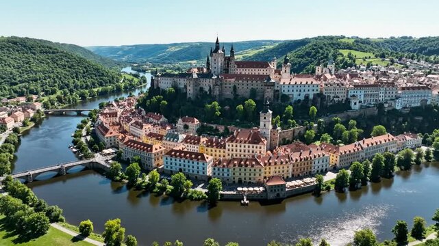 Aerial view of Cesky Krumlov, Czech Republic, featuring the castle, river, and historic architecture on a sunny day