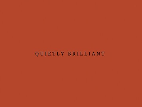 Minimalist typography poster quietly brilliant elegant inspirational short quote on terracotta background