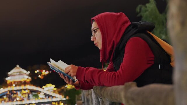 Night city reading traveler on railing with backpack, guidebook open against glowing skyline, leaning over lookout, quiet contemplation and urban lights, warm bokeh and reflective mood