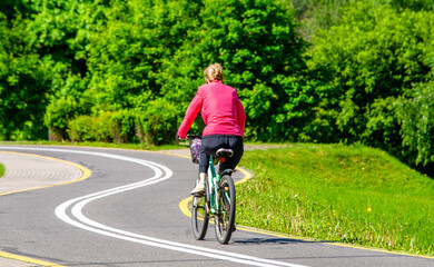 Naklejka premium Cyclist ride on the bike path in the city Park