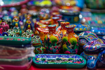 Fototapeta premium Colorful Handcrafted Pottery Souvenirs Displayed on a Market Stall