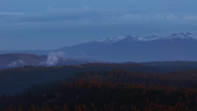 Aerial of Wallowa Mountains snow capped peaks at blue hour in east Oregon in spring time