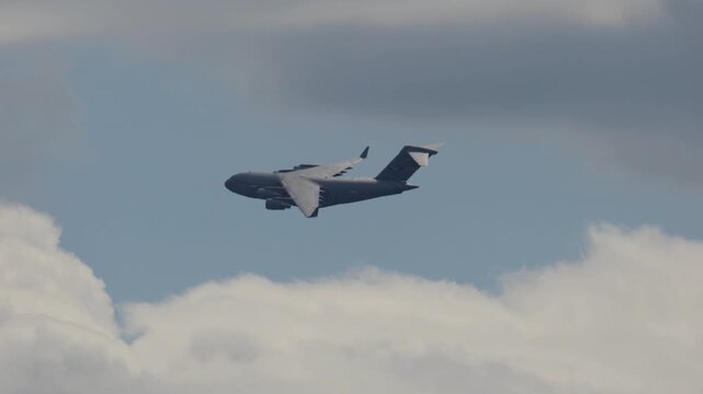 C-17 Globemaster performs tactical maneuvers during military logistics operation in cloudy skies