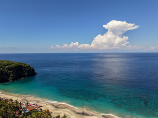 Fototapeta premium High angle view of Virgin Beach with turquoise water and dramatic cumulus clouds, Karangasem, Bali