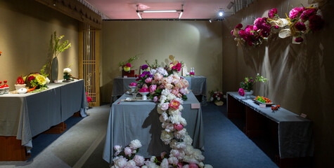 Chinese-style indoor artistic flower arrangement of colorful precious peonies with light and shadow. © 肖勇