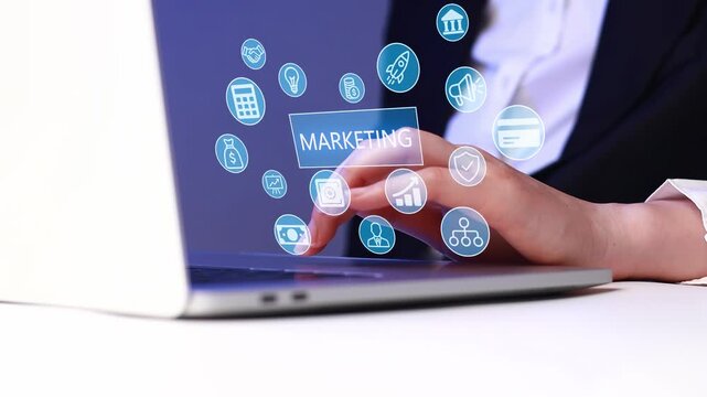 Person using laptop with marketing icons in background during work hours in office setting.