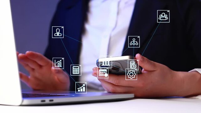 Business professional using smartphone and laptop to manage tasks and data with digital tools in a modern office setup.