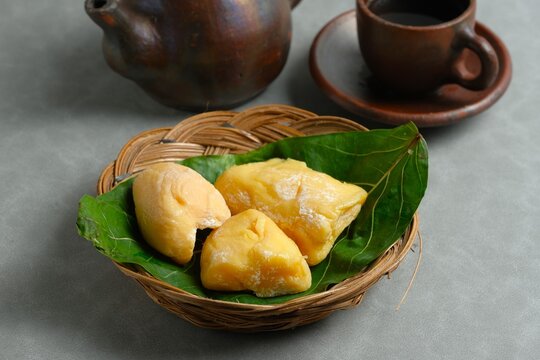 Traditional Indonesian fermented yellow cassava tape on plate, sweet and sour tape singkong