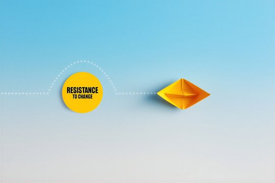 Yellow origami paper boat overcoming resistance to change with a conceptual visual metaphor