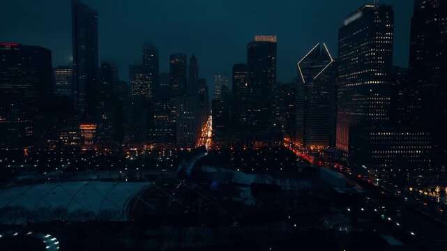 Night aerial view of Chicago skyline with Millennium Park and car traffic on Michigan Avenue.
