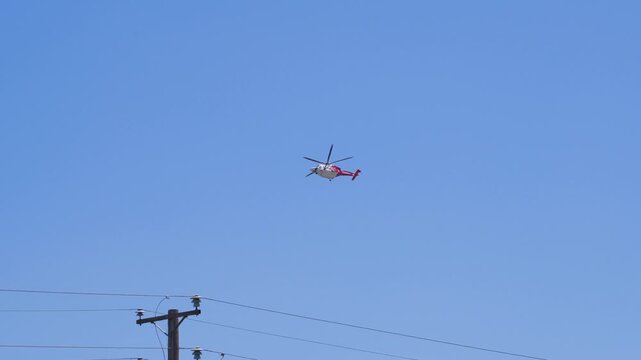 Slow motion shot of Los Angeles Fire Department responding to wildfire with aerial unit dropping water 
