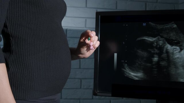 Female hold birth control pill. A pregnant woman control the birth control with pills 