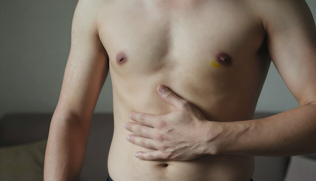 Shirtless Man Holding His Stomach Suffering from Abdominal Pain