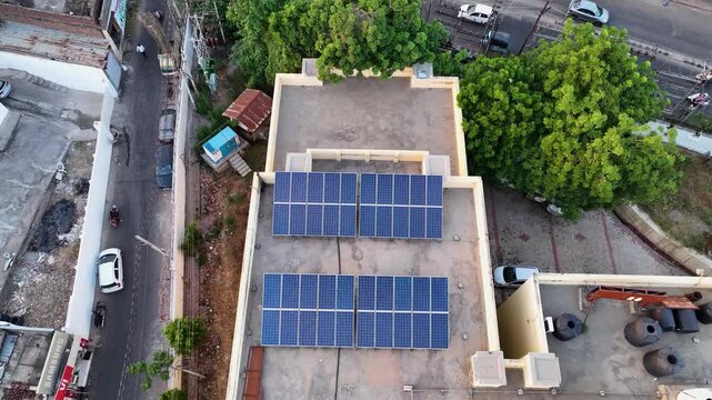 Aerial view of rooftop solar panels on residential homes in India.